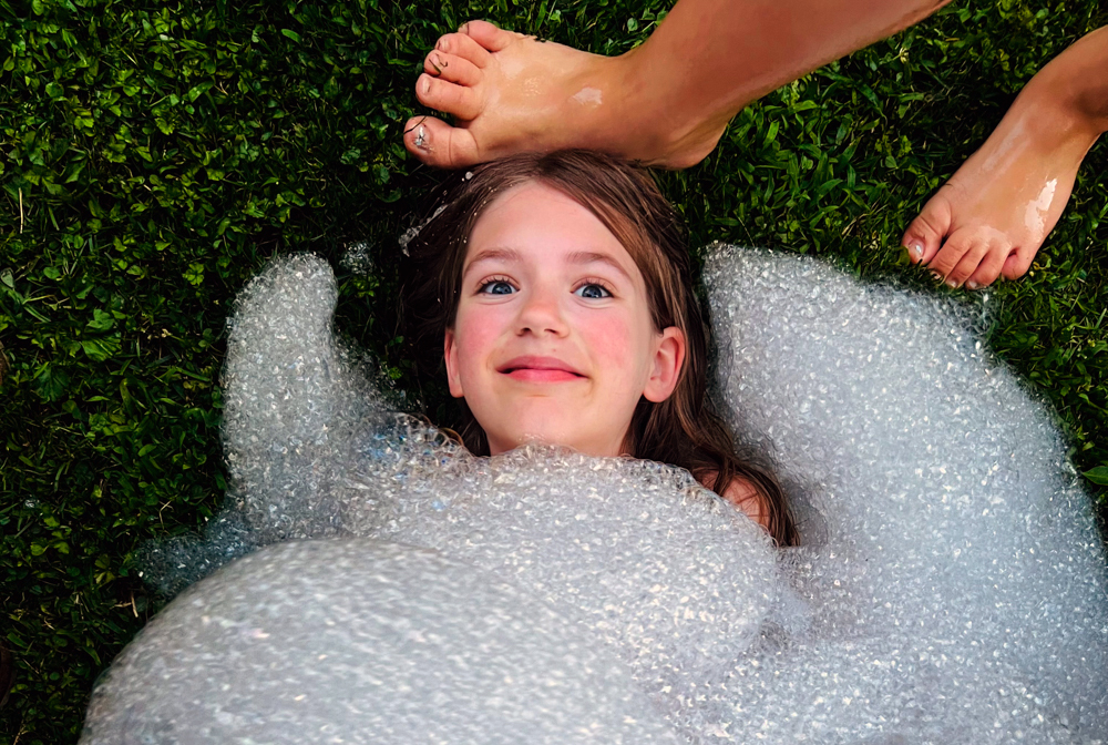 Foam Party Trend: How to Throw a Foam Party for Kids Getting buried in bubbles is much less messy than getting buried in sand! Photo by Ally Noel for Mommy Poppins