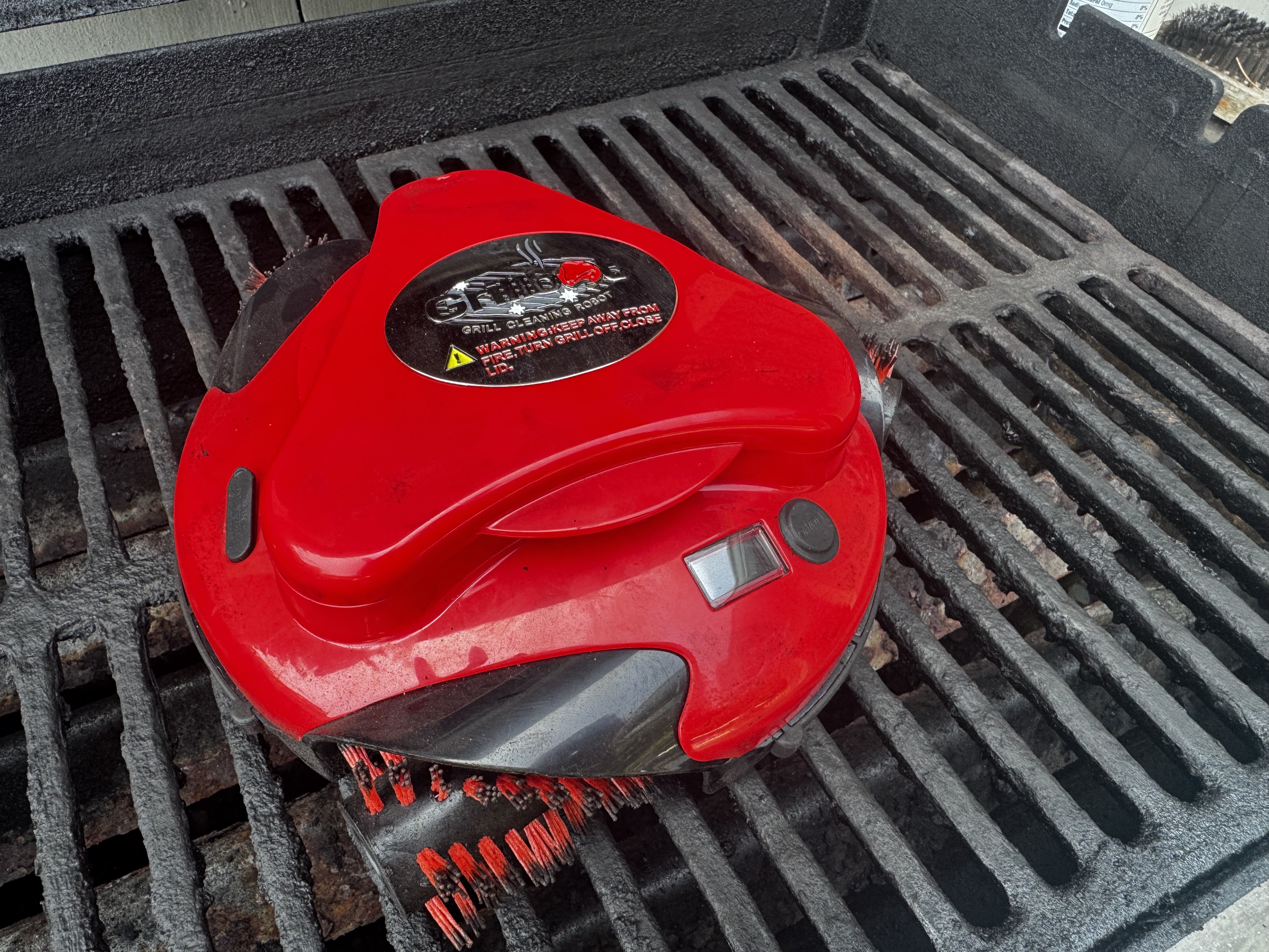 The Grillbot at work on a dirty grill.