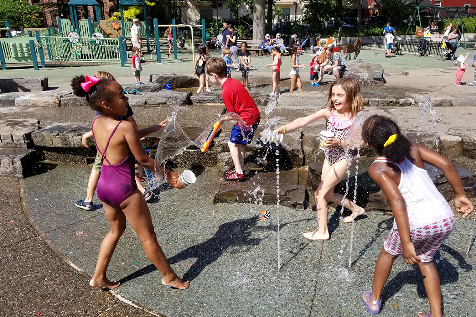 Things To Do in Brooklyn kids playing in the sprinklers at J.J. Byrne Park